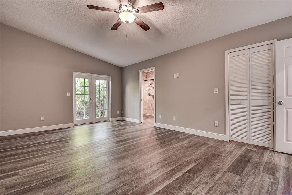 289 Whisper Lake Road Palm Harbor, FL 34683 - Photo 7 of 40 a view of an empty room with a window and wooden floor