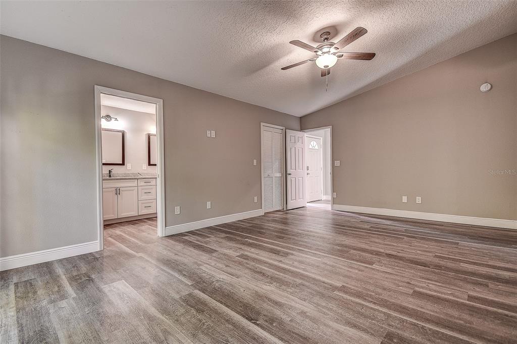 289 Whisper Lake Road Palm Harbor, FL 34683 - Photo 8 of 40 a view of an empty room with window and wooden floor
