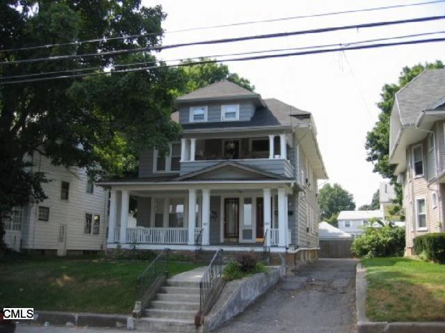 3183 Main Street Bridgeport, CT 06606 - Photo 1 of 1 a front view of a house with a garden