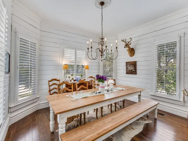 a large white kitchen with a large window