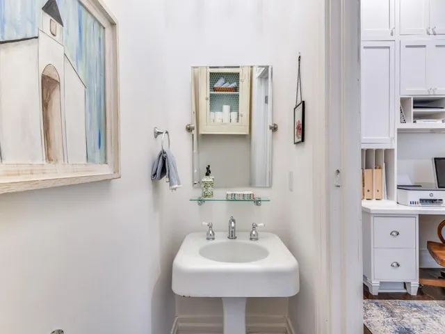 a bedroom with a bed and dresser with mirror