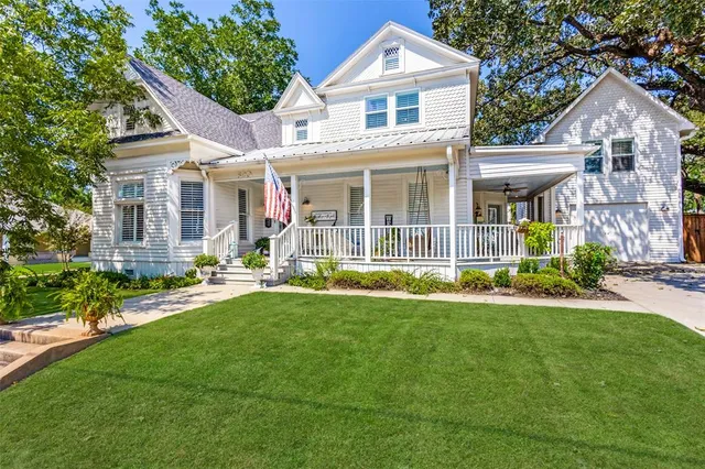 a front view of a house with a yard and porch
