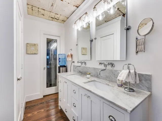 a bedroom with furniture and a wooden floor
