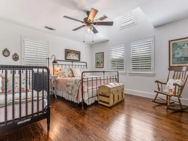 a bathroom with a granite countertop sink a mirror and shower