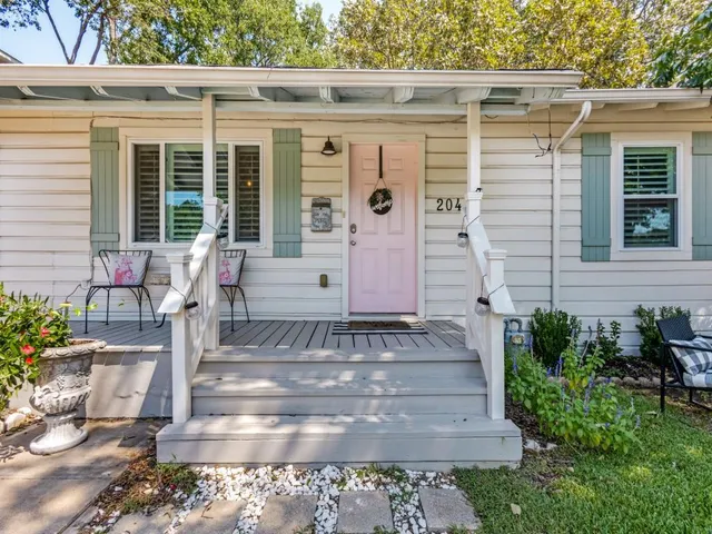 a living room with furniture a flat screen tv and a floor to ceiling window