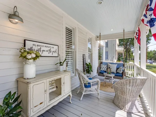a living room with furniture and flowers