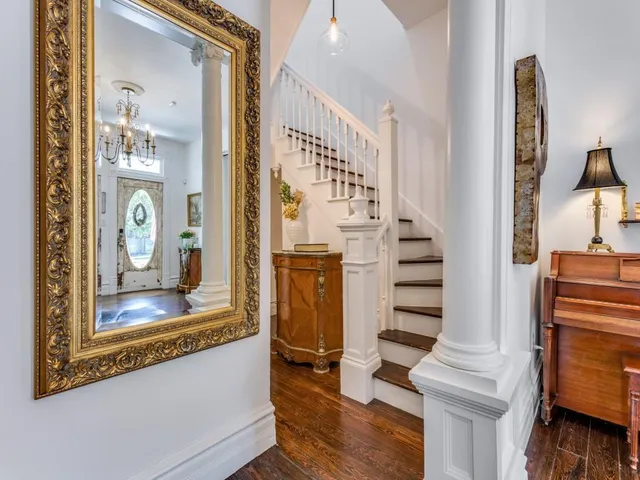 a living room with fireplace furniture and a chandelier