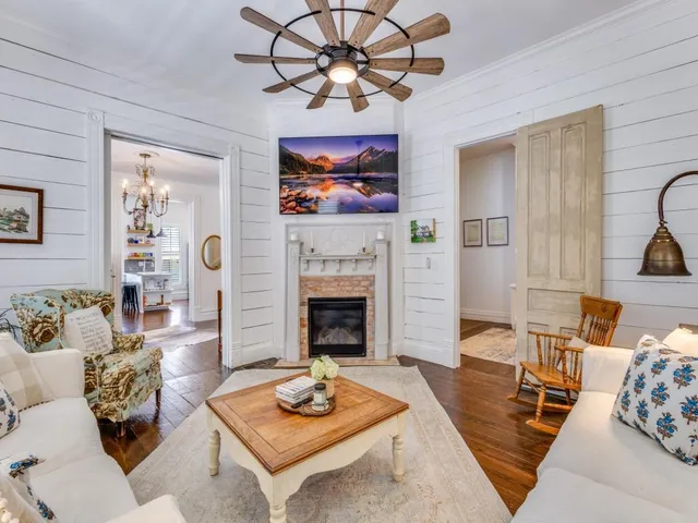 a view of a dining room with furniture a chandelier and wooden floor