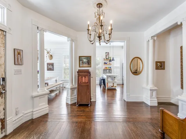 a view of a dining room with furniture wooden floor and chandelier