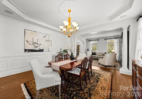 a view of a dining room with furniture wooden floor and a chandelier