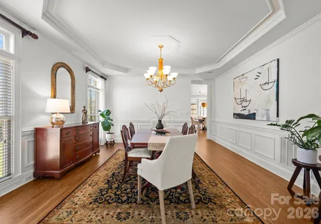 a living room with furniture a chandelier and a rug