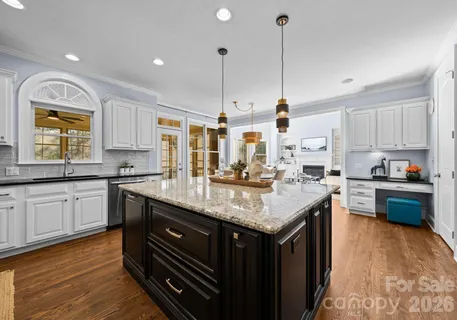 a kitchen with a sink stove and wooden cabinets