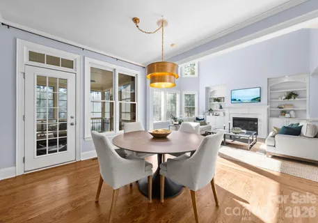 a view of a dining room with furniture wooden floor and a chandelier
