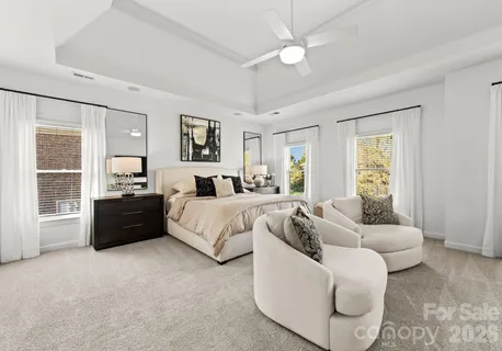 a spacious bedroom with a bed and a couch
