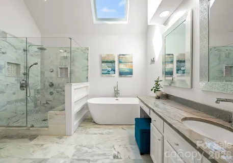 a bathroom with a granite countertop sink and a bathtub