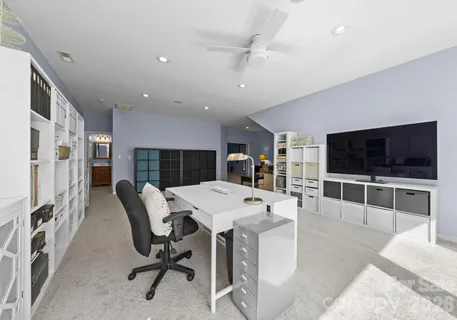 a view of a livingroom with furniture and a flat screen tv