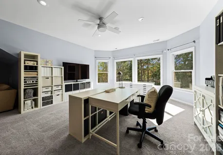 a view of a livingroom with furniture and a flat screen tv