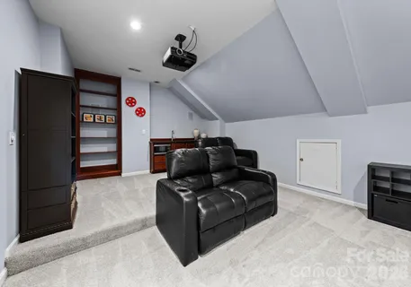 a living room with furniture and a ceiling fan