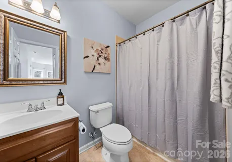 a bathroom with a toilet a sink and a mirror