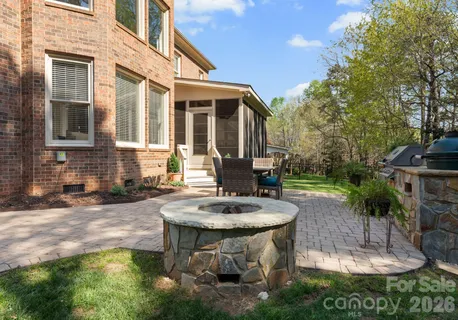 a view of a house with backyard fountain and sitting area