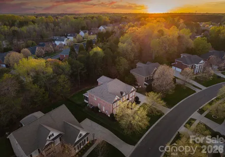 an aerial view of a house with a mountain
