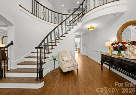 a view of entryway and hall with wooden floor