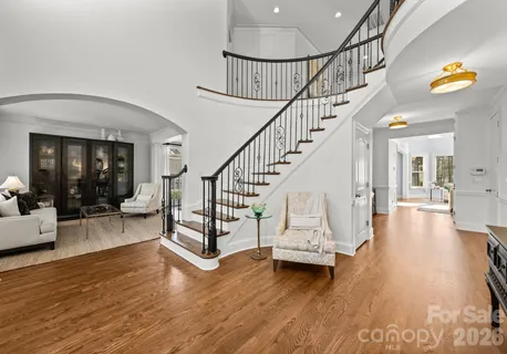 a view of entryway and hall with wooden floor