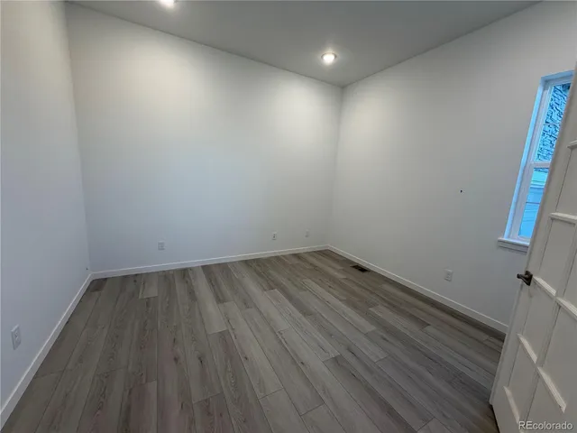 a view of a room with wooden floor