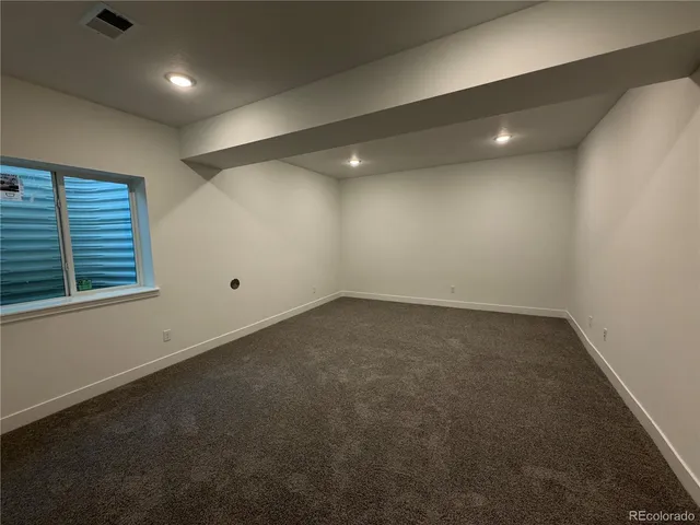 an empty room with a empty space and windows