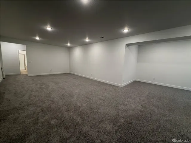 an empty room with a empty space and windows