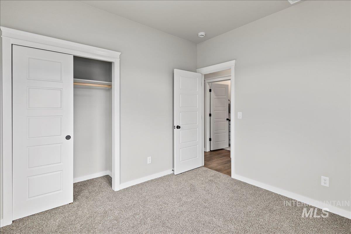 1228 Creekside Way Twin Falls, ID 83301 - Photo 13 of 28 Unfurnished bedroom featuring carpet floors and a closet