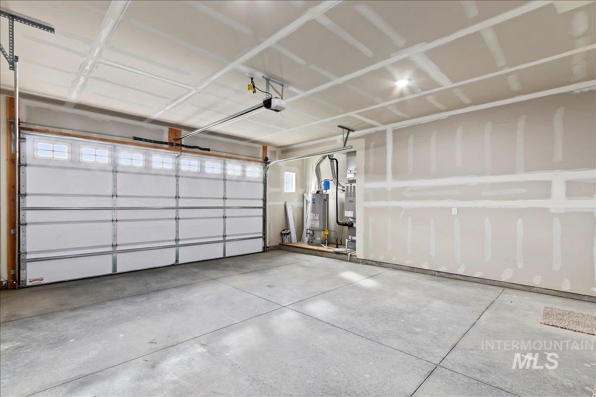 1228 Creekside Way Twin Falls, ID 83301 - Photo 22 of 28 Garage with water heater and a garage door opener