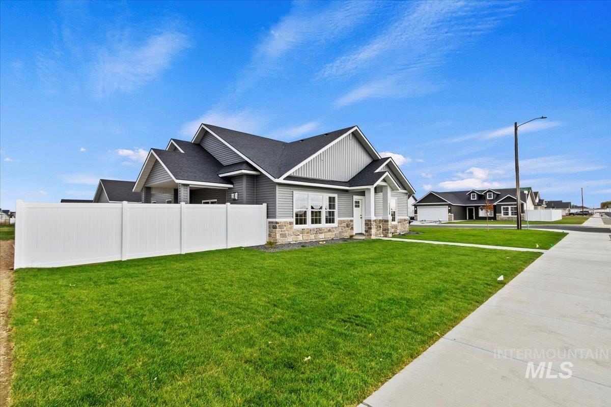 1228 Creekside Way Twin Falls, ID 83301 - Photo 3 of 28 View of home's exterior with stone siding and roof with shingles