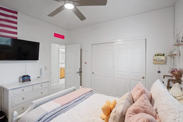 a bedroom with a bed a desk and a window