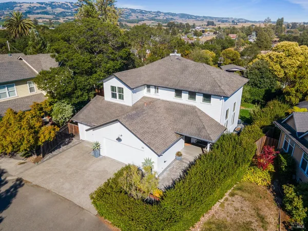 an aerial view of a house with a yard