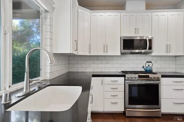 a kitchen that has a sink and a stove in it