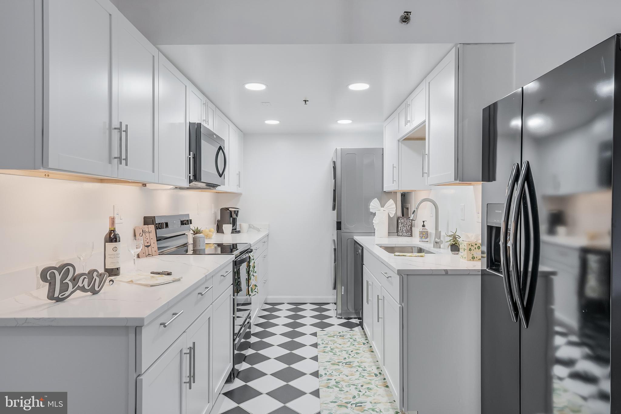 5911 Edsall Road, Unit 708 Alexandria, VA 22304 - Photo 1 of 39 a kitchen with stainless steel appliances a sink a stove a refrigerator cabinets and a dining table
