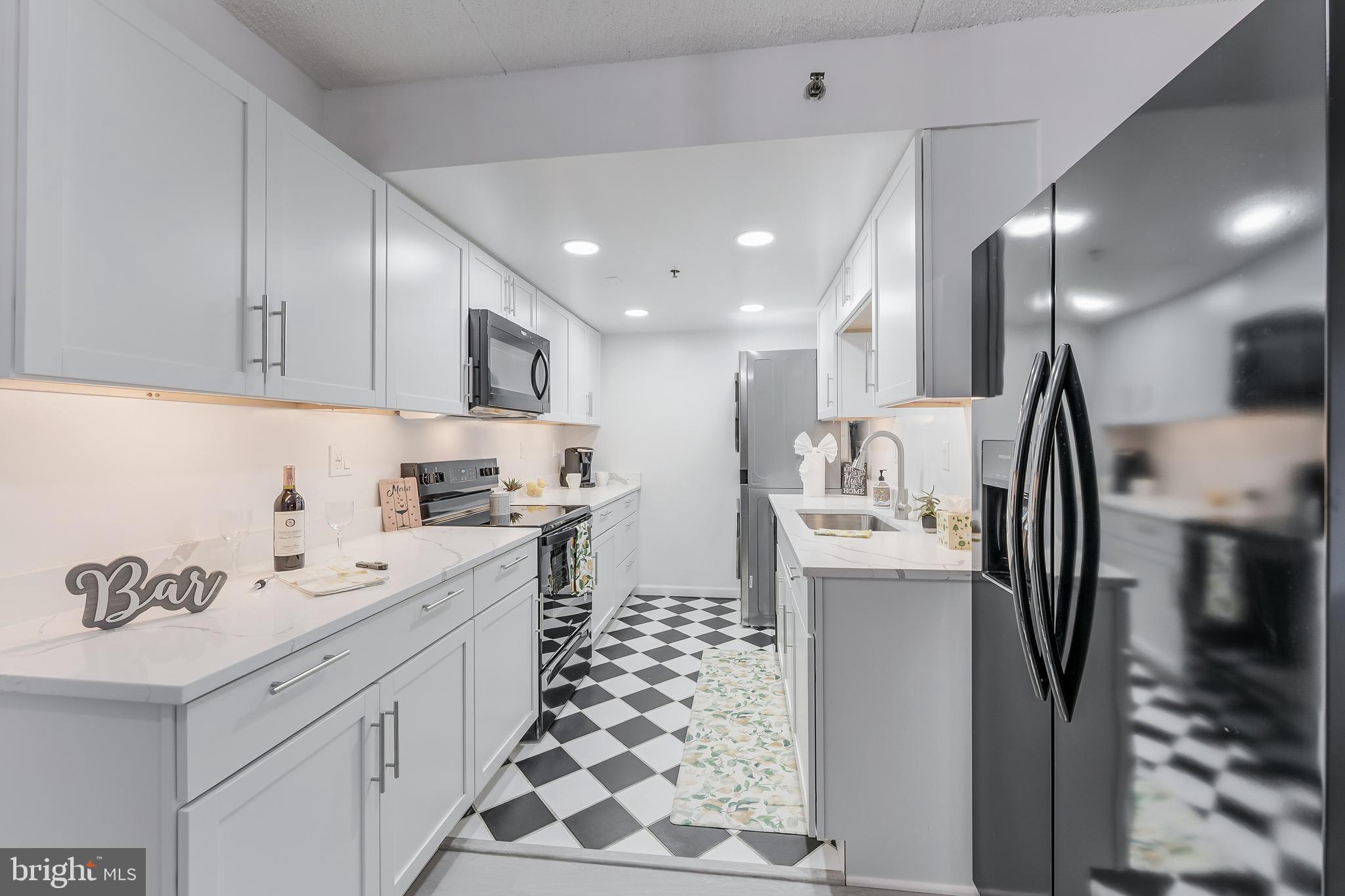 5911 Edsall Road, Unit 708 Alexandria, VA 22304 - Photo 11 of 39 a kitchen with a sink appliances and cabinets