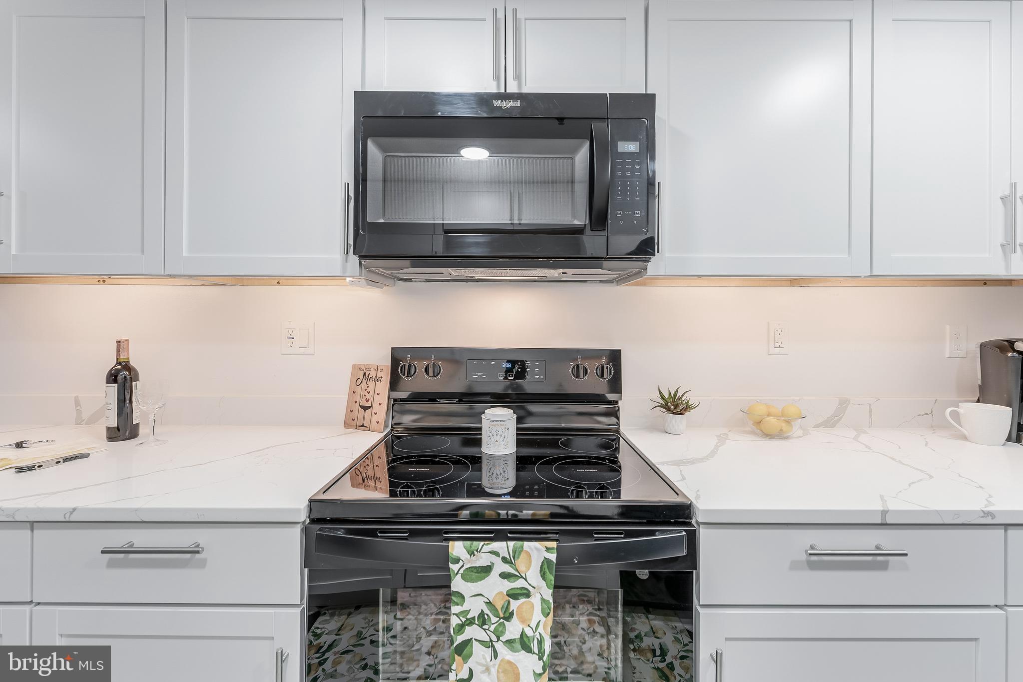 5911 Edsall Road, Unit 708 Alexandria, VA 22304 - Photo 12 of 39 a kitchen with a stove and a microwave