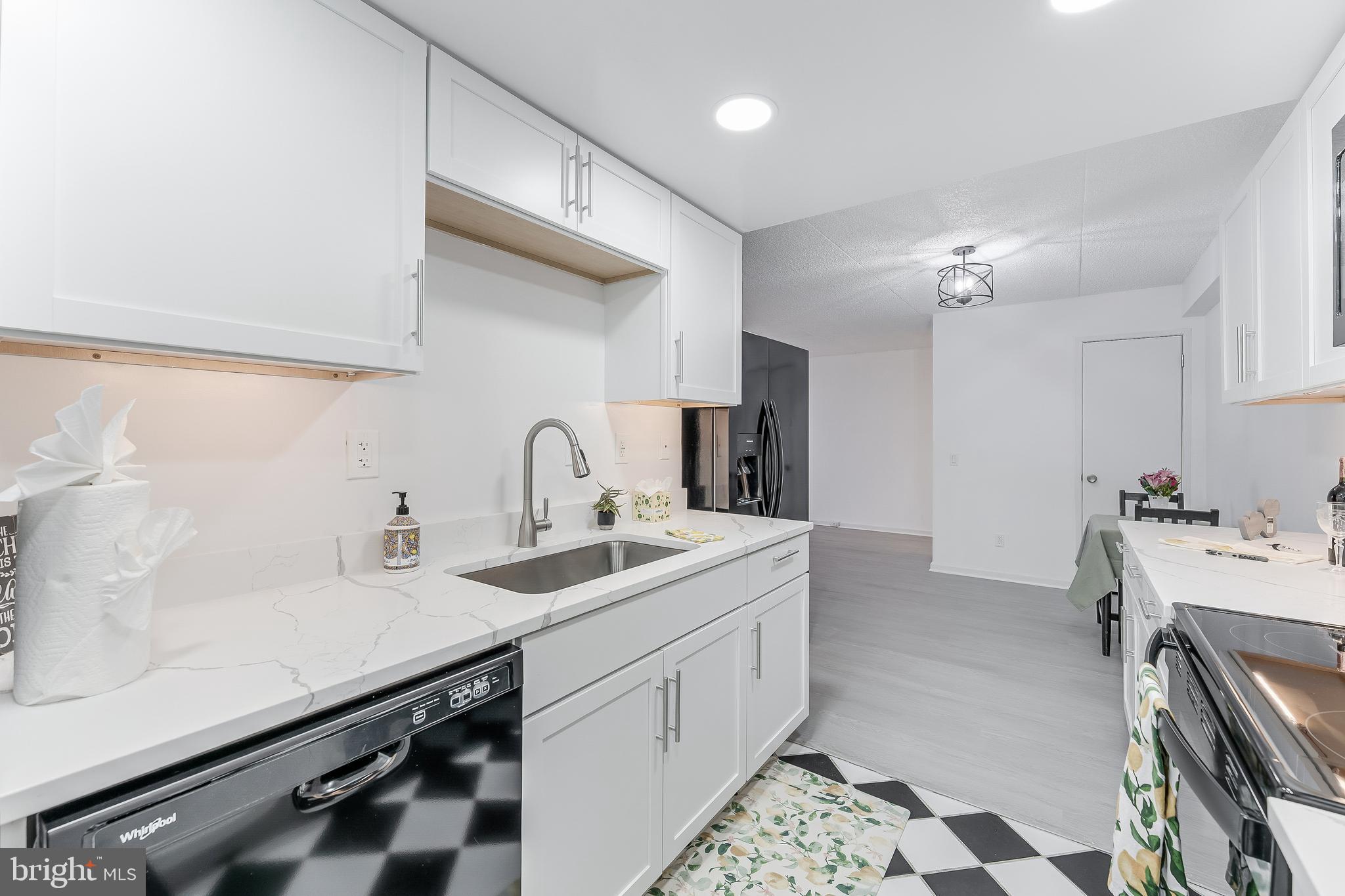 5911 Edsall Road, Unit 708 Alexandria, VA 22304 - Photo 14 of 39 a kitchen with a sink and a stove top oven