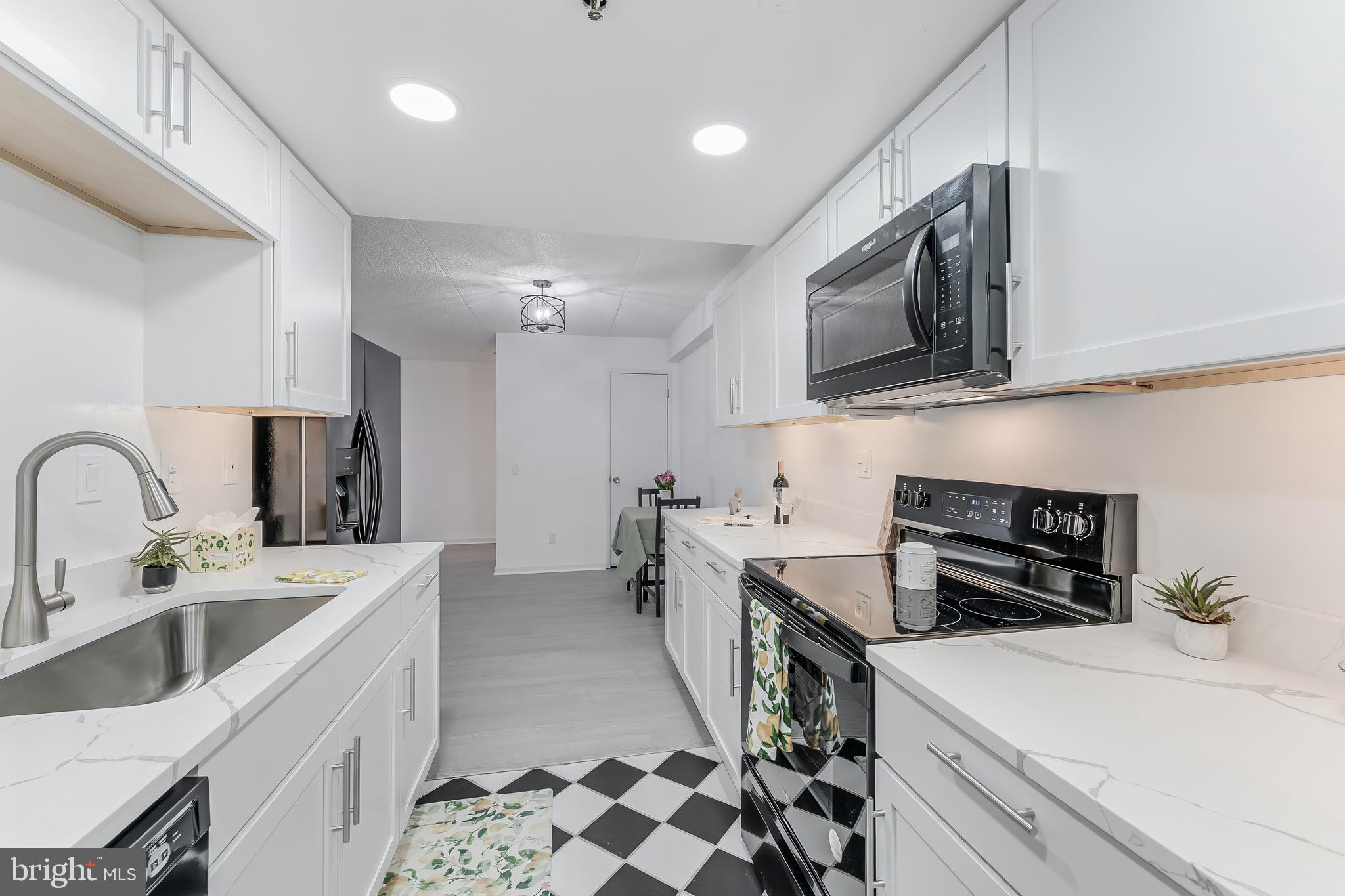 5911 Edsall Road, Unit 708 Alexandria, VA 22304 - Photo 15 of 39 a kitchen that has a sink and a stove in it