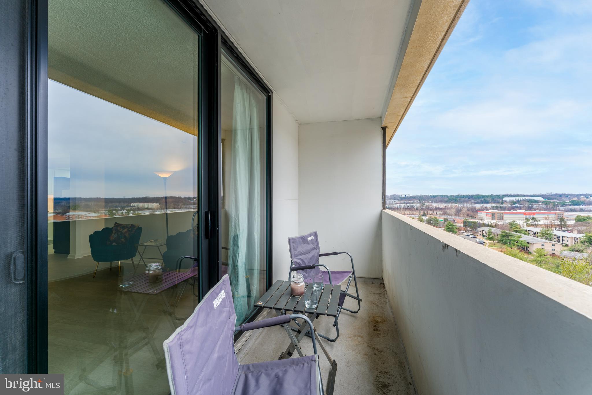 5911 Edsall Road, Unit 708 Alexandria, VA 22304 - Photo 23 of 39 a view of a balcony with chair and floor to ceiling window