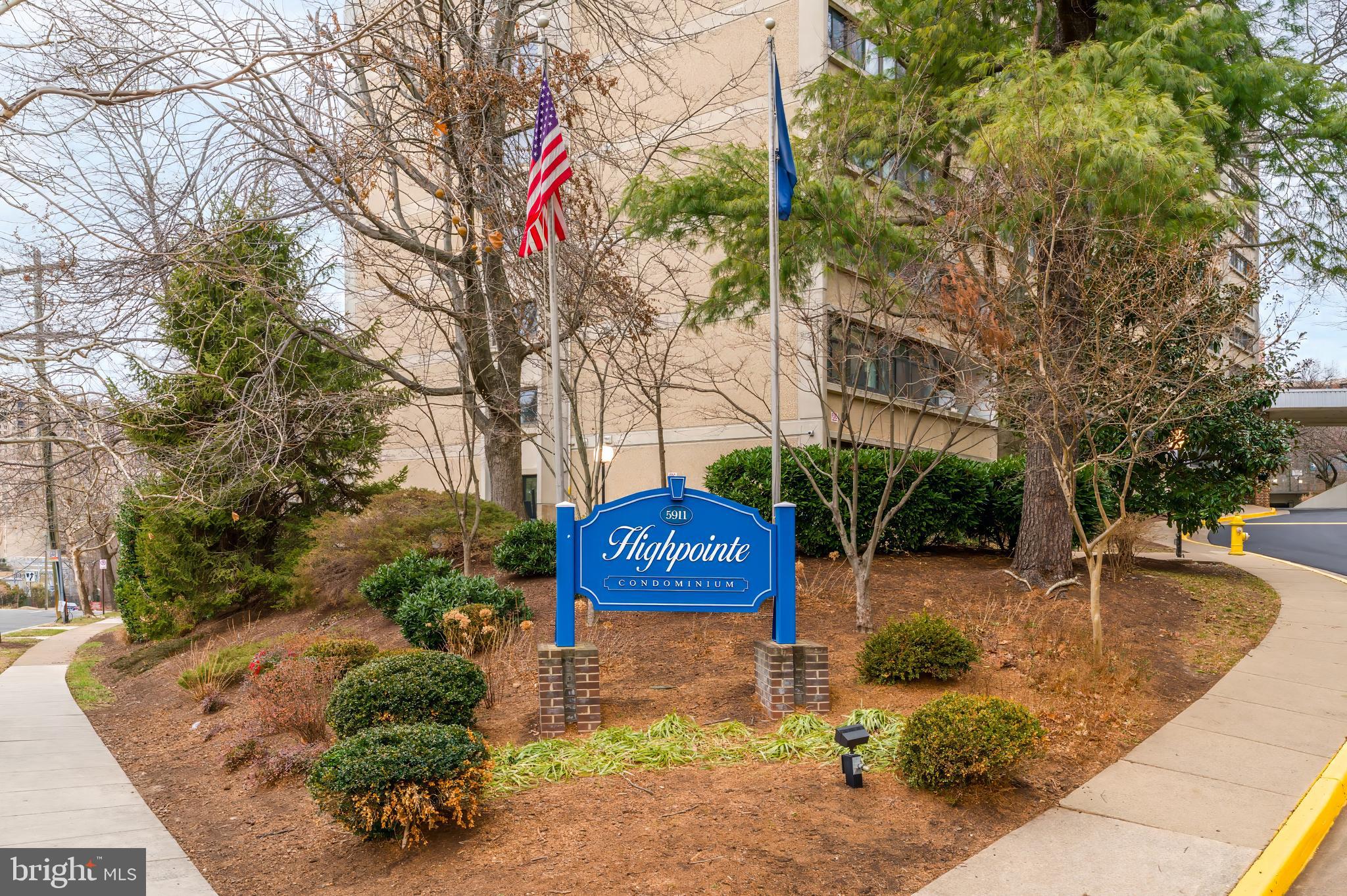 5911 Edsall Road, Unit 708 Alexandria, VA 22304 - Photo 38 of 39 a view of a street with potted plants and large trees