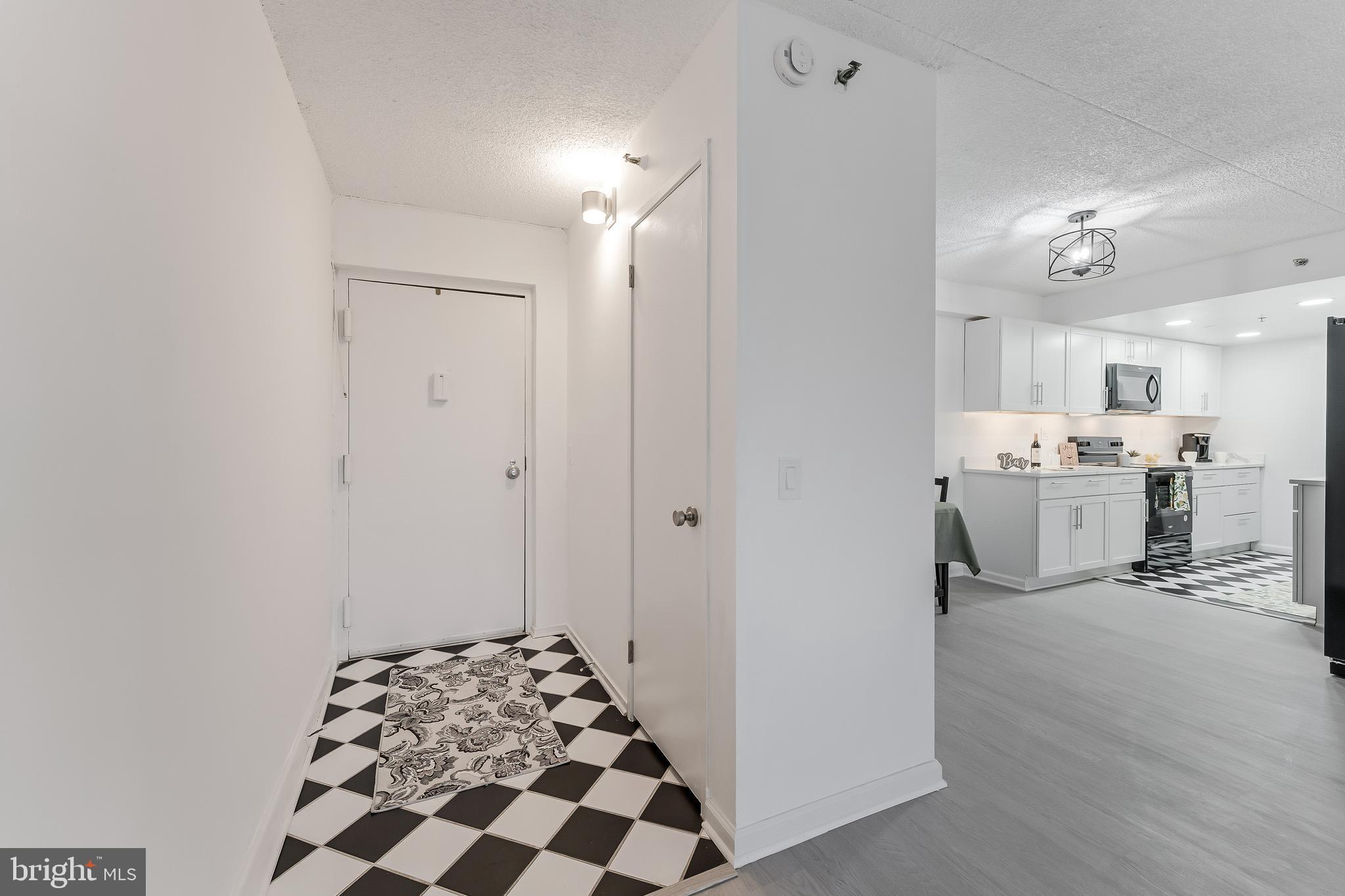 5911 Edsall Road, Unit 708 Alexandria, VA 22304 - Photo 4 of 39 a view of a kitchen with refrigerator and cabinets