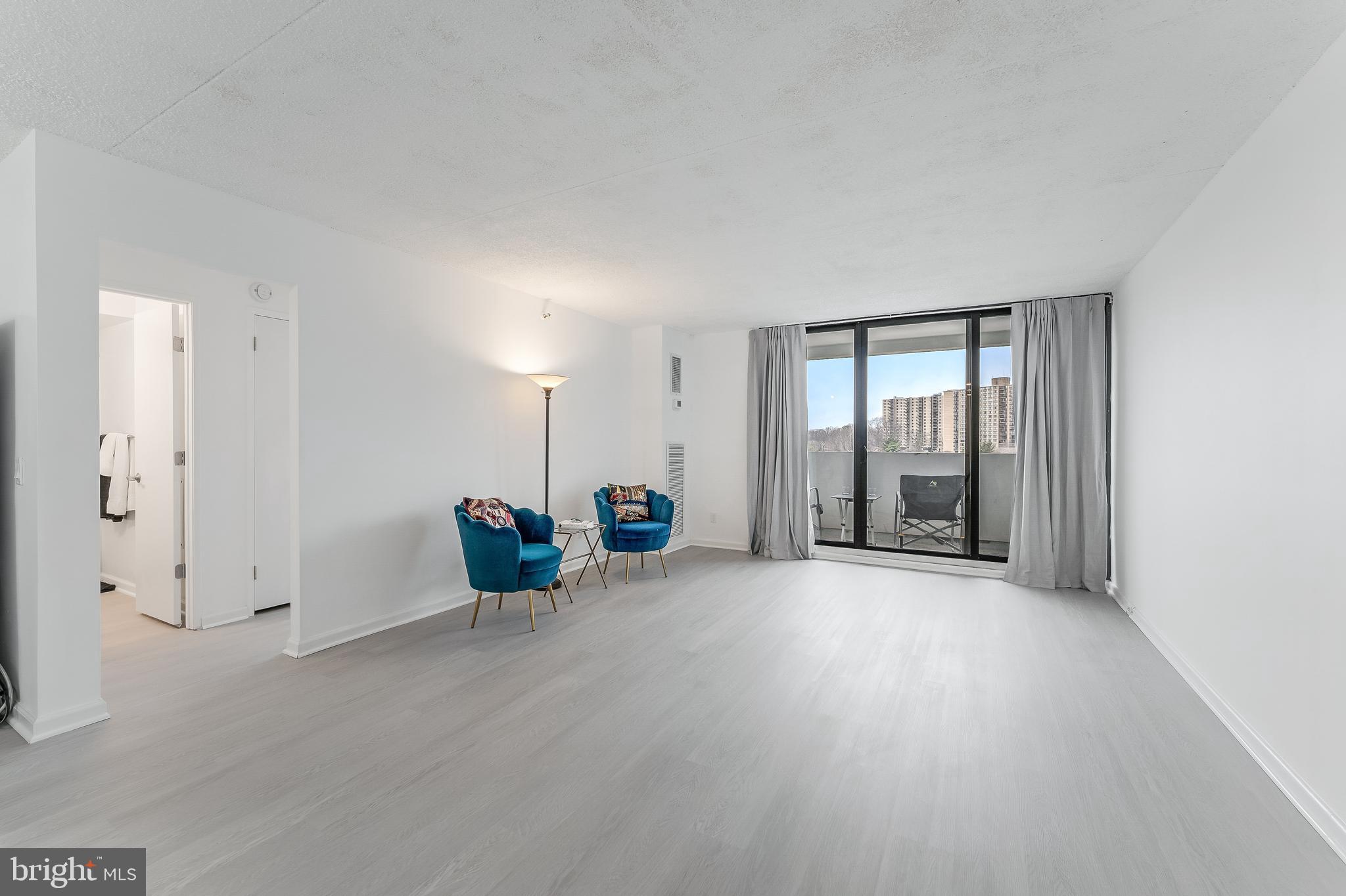 5911 Edsall Road, Unit 708 Alexandria, VA 22304 - Photo 5 of 39 an empty room with sliding door and windows