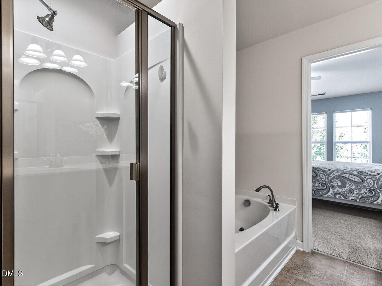 8215 Yaxley Hall Drive Raleigh, NC 27616 - Photo 23 of 42 a bathroom with a tub sink and mirror