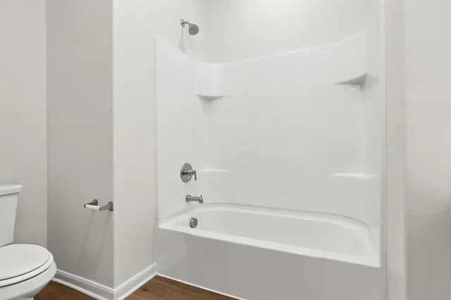 a bathroom with a bathtub and toilet