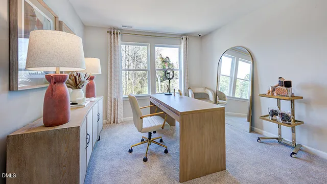 a spacious bedroom with a bed a dresser and a chandelier