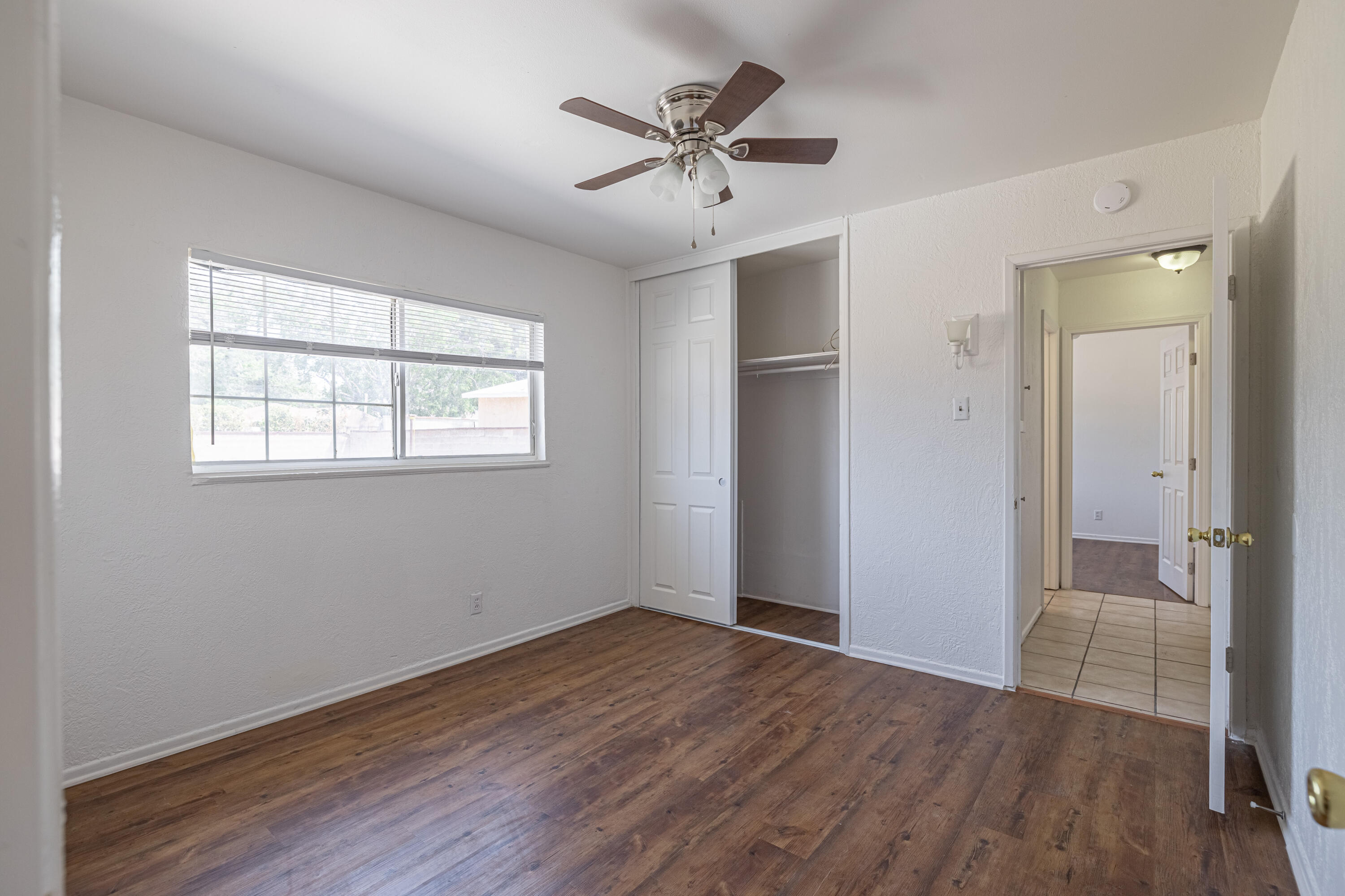 44272 Glenraven Road Lancaster, CA 93535 - Photo 11 of 21 wooden floor in an empty room with a window