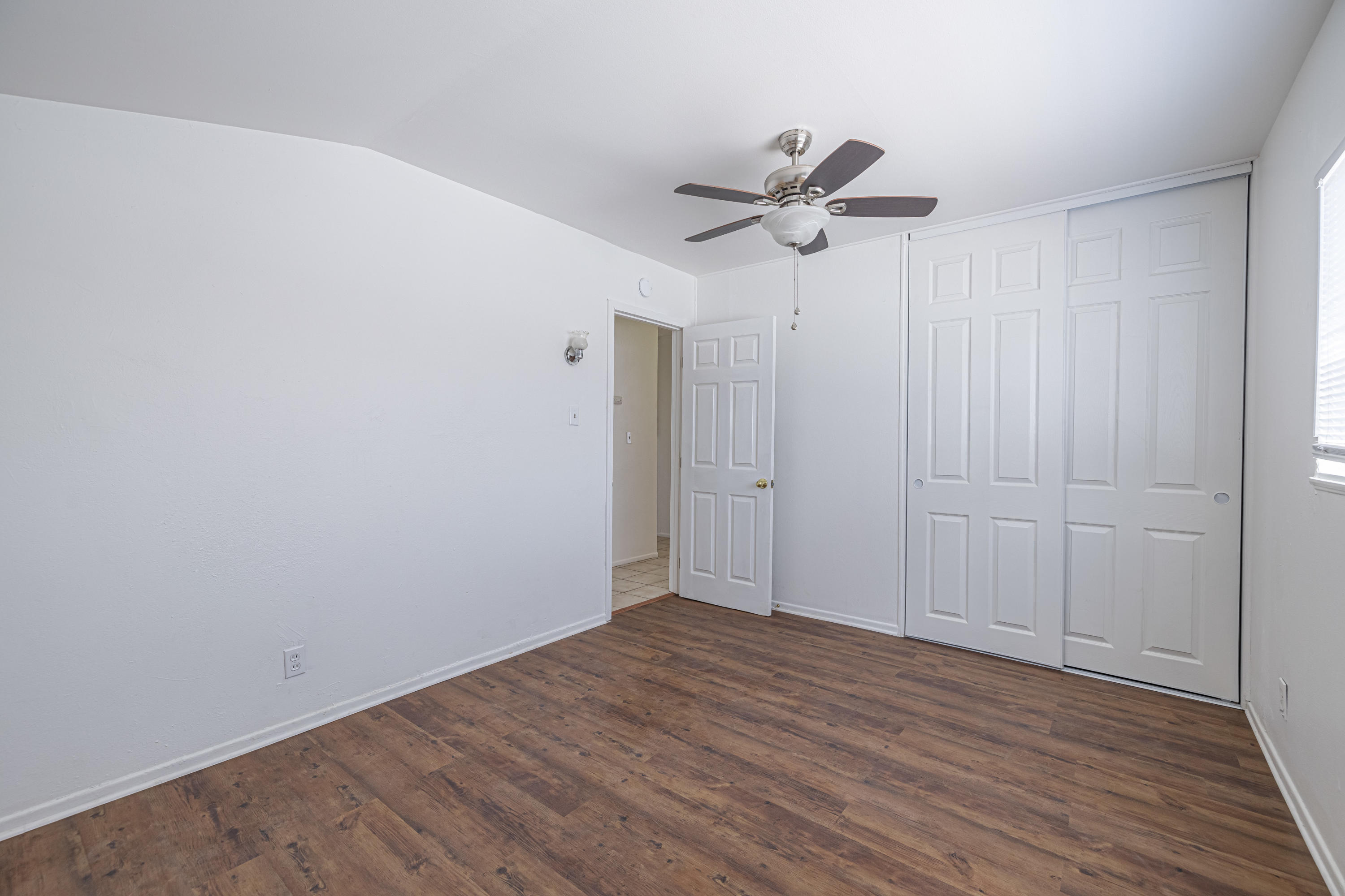 44272 Glenraven Road Lancaster, CA 93535 - Photo 16 of 21 a view of empty room with wooden floor and fan